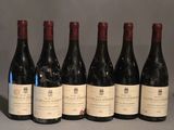 six bottles of wine are lined up in a row on a table
