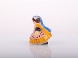 a small figurine of a woman with a blue hair