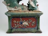 a figurine of a man and a woman sitting on a bench