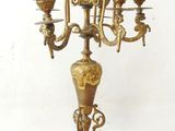 a brass candelab with three candles on it