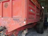 a red dump truck that is parked in a barn