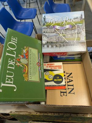 boxes of books are stacked on top of each other in a classroom