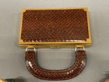 a brown purse sitting on top of a table next to a pair of shoes