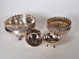 two silver dishes and a silver bowl on a white surface