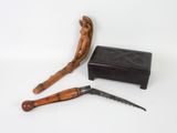 a knife, a box, and a knife on a white surface