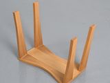 a wooden holder that has three sticks sticking out of it