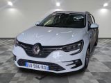 the front end of a white car in a room with checkered floor