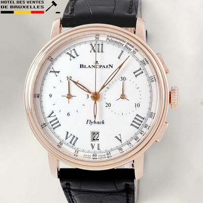 a close up of a watch with roman numerals on it