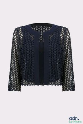 a woman is wearing a black jacket with a lace pattern