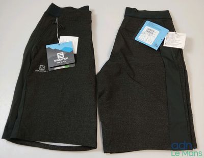 two pairs of men ' s black pants with tags on them