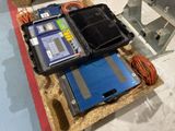 a box with wires and other equipment on the floor