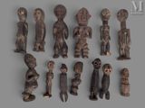 several wooden figurines of different shapes and sizes on a gray surface