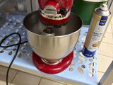 a stand with a mixer and other kitchen items on it