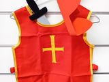 a red vest with a cross on it hanging on a wall