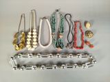 a lot of different necklaces and bracelets on the table