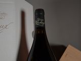 a bottle of wine sitting on a table next to a box