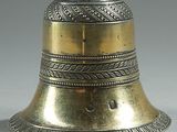 a silver bell with a lion on top of it