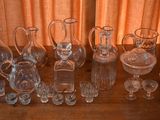 a lot of glass vases and glasses on the table