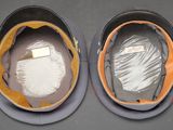 two helmets that are sitting on a table
