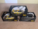 three boxed boxes of toy cars sitting on top of a table