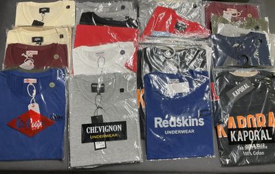 a lot of t - shirts that are on a table