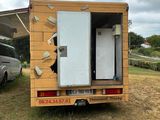 a truck that has a refrigerator in the back of it