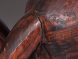 a close up of a wooden elephant statue on a table