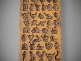 a wooden plaque with a variety of symbols on it