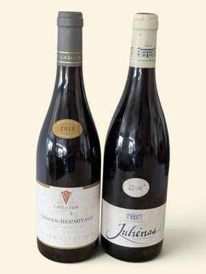 two bottles of wine sitting next to each other on a table