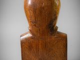 an image of a wooden sculpture of a person with a hat on