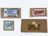 four cards with drawings of flowers and birds on them on a white surface
