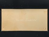an image of a picture of a gold plate on a black background