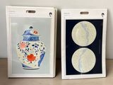 two framed pictures of a vase and a vase on a table
