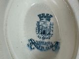 a close up of a plate with a royal crest on it