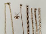 many different types of necklaces on a white surface