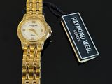 an image of a gold watch with a tag on a black surface