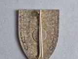 a close up of a small metal object on a white surface