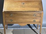 an old wooden desk with three drawers on top of it