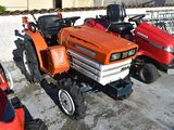 three lawn mowers parked next to each other in a parking lot
