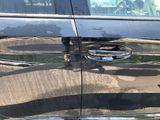 a reflection of a person in the door of a car
