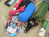 a bag with a skateboard and other items on the floor