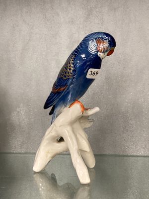une figurine représentant un oiseau bleu perché sur une branche