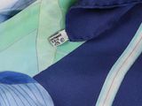 a close up of a blue shirt with a green and white stripe