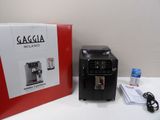a black coffee machine sitting next to a red box