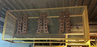 a large metal sign that is above a shelf