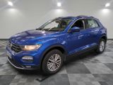 a blue volkswagen suv parked in a showroom