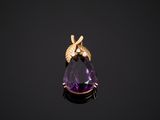 an amethorate and gold pendant with a bee on it