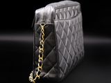 a close up of a black purse with a chain on it