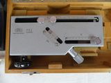 a silver electronic device inside of a wooden box