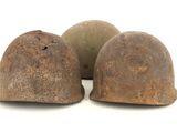 three helmets are sitting on a white surface with a white background